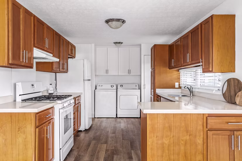 Modern kitchen with stainless steel appliances and granite countertops at Kapilina Beach Homes Apartments
