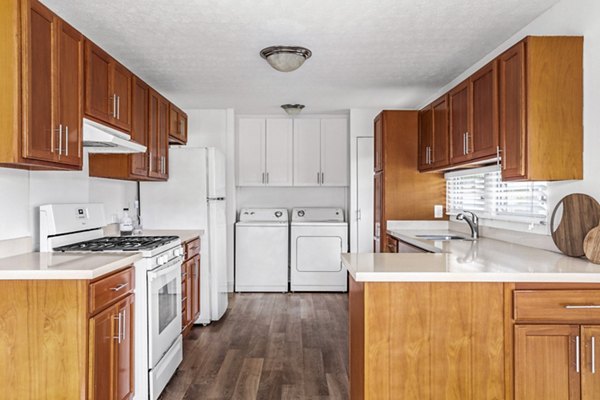 Modern kitchen with stainless steel appliances and granite countertops at Kapilina Beach Homes Apartments