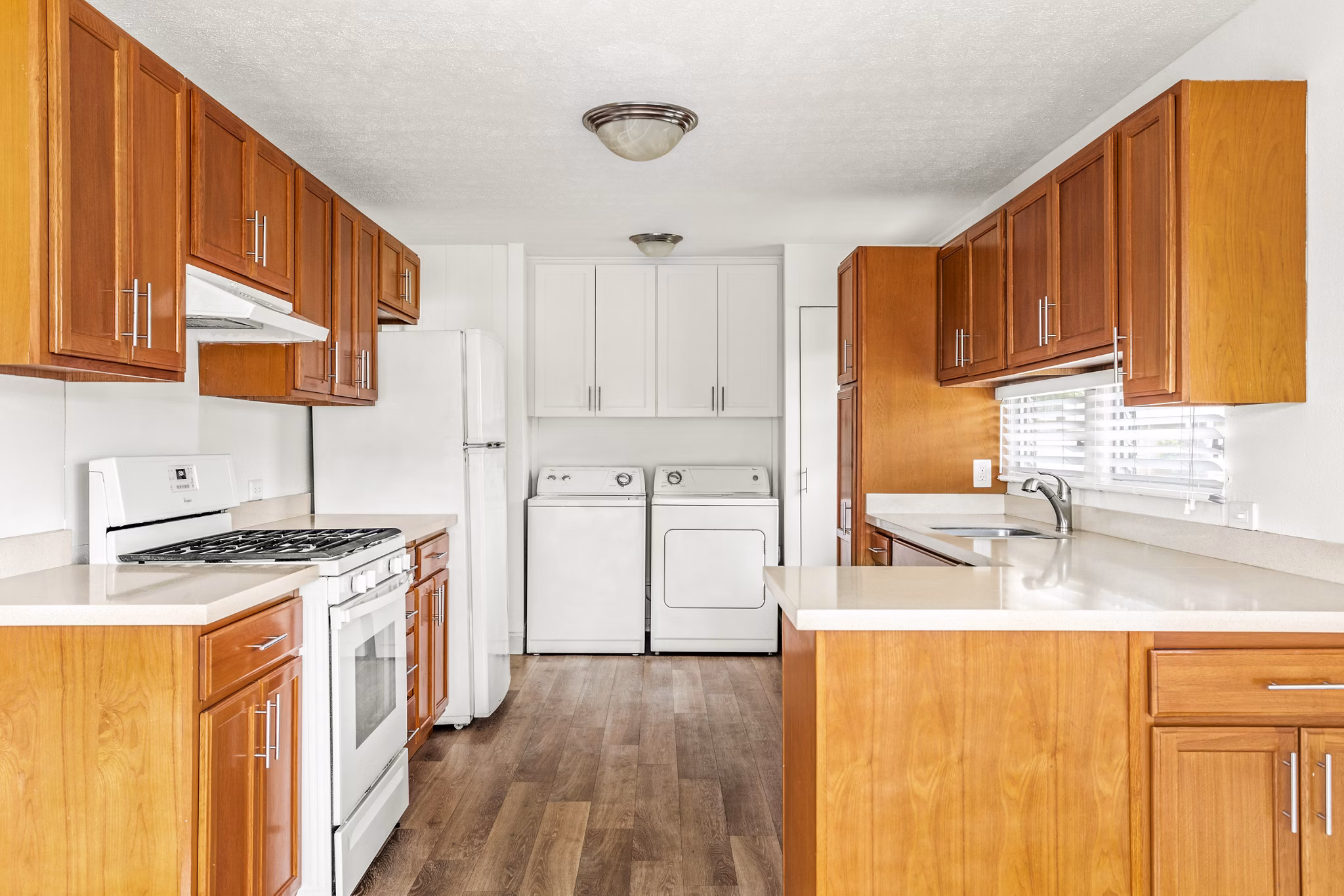 Modern kitchen with stainless steel appliances and granite countertops in Kapilina Beach Homes Apartments