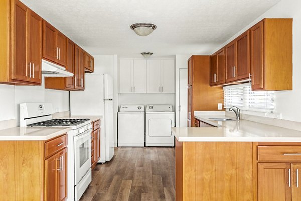 Modern kitchen with stainless steel appliances and granite countertops in Kapilina Beach Homes Apartments