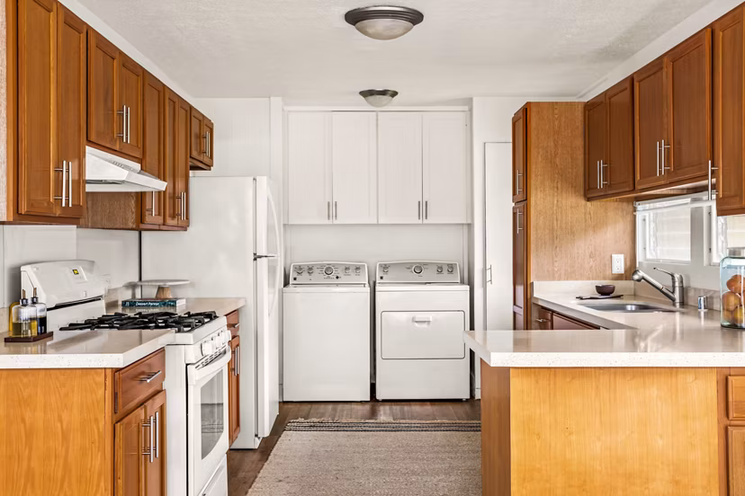 Modern kitchen with stainless steel appliances in Kapilina Beach Homes Apartments, offering luxury living near the ocean