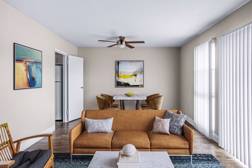 Spacious living room with cozy seating and ocean views in Kapilina Beach Homes Apartments