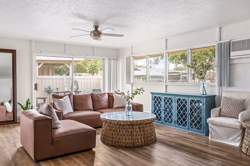 Bright living room with ocean views at Kapilina Beach Homes Apartments, featuring comfortable seating and modern decor