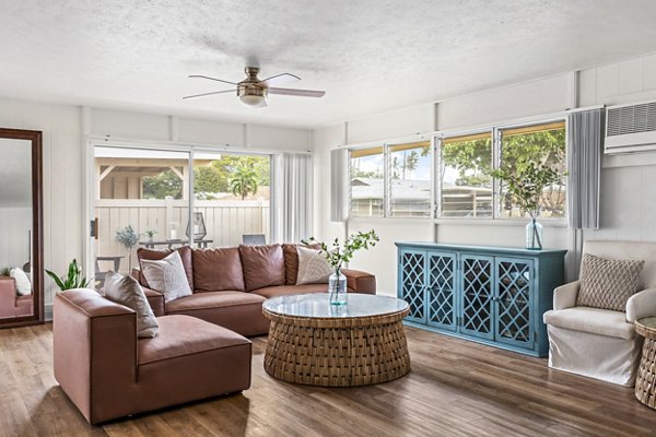 Bright living room with ocean views at Kapilina Beach Homes Apartments, featuring comfortable seating and modern decor