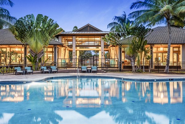 Resort-style pool with lounge chairs at Kapilina Beach Homes Apartments, offering luxury living with ocean views in Ewa Beach