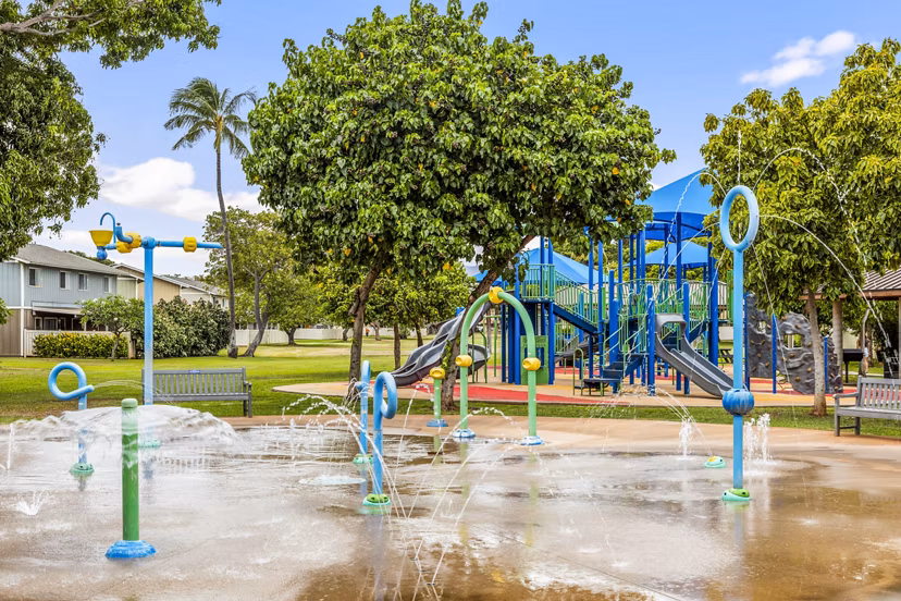 Family-friendly playground and water park at Kapilina Beach Homes Apartments, offering fun outdoor activities for residents