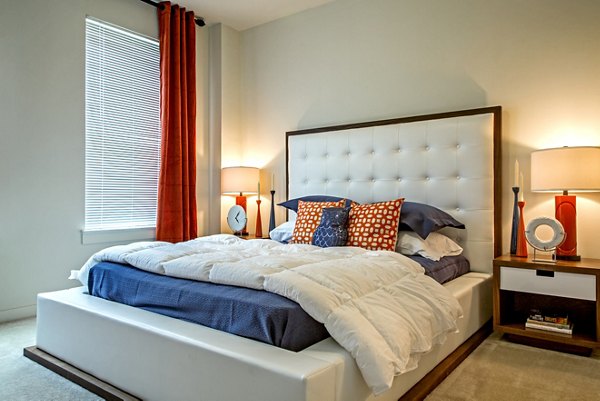 Modern bedroom with plush bedding and city views at Watervue Apartments