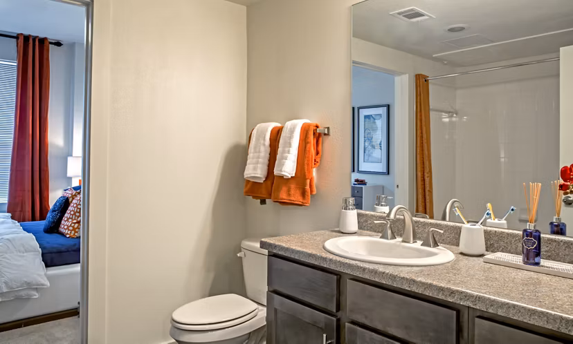 Modern bathroom with dual sinks and stylish backsplash in Watervue Apartments