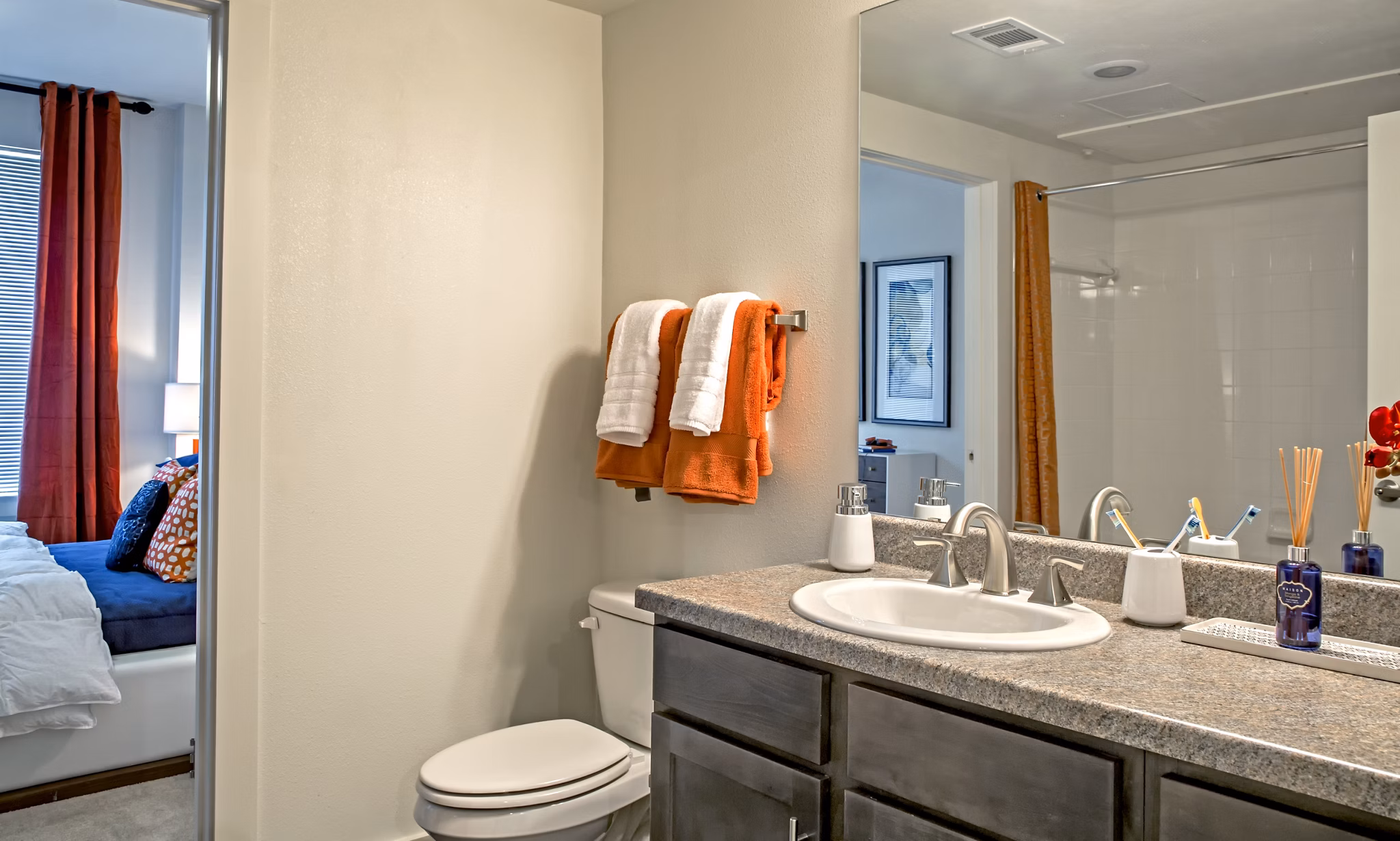Modern bathroom with dual sinks and stylish backsplash in Watervue Apartments