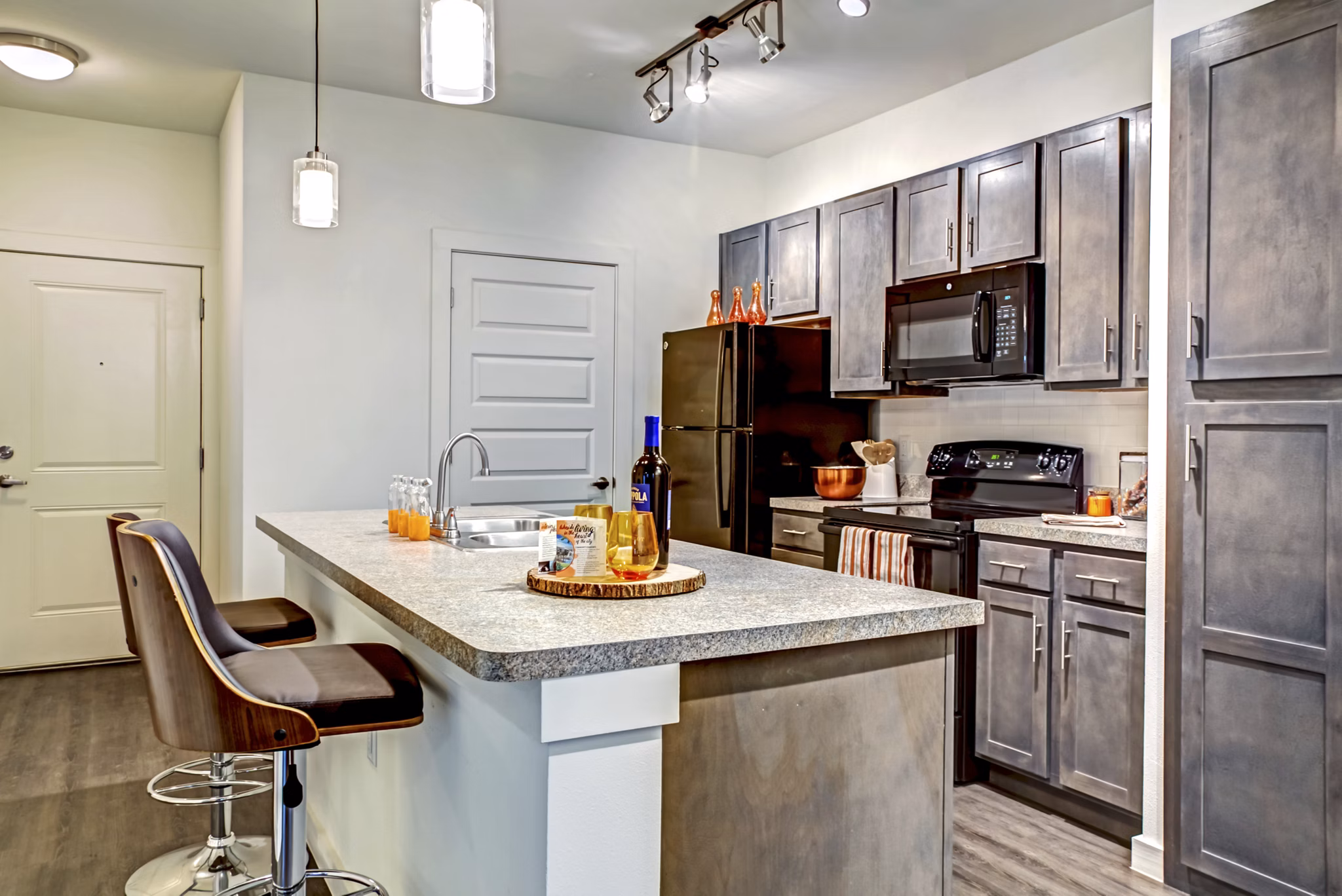 Modern kitchen with stainless steel appliances at Watervue Apartments, offering luxury living in a serene setting