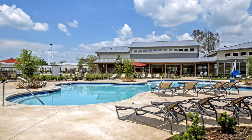 Resort-style pool at Watervue Apartments with lounge seating and landscaped surroundings