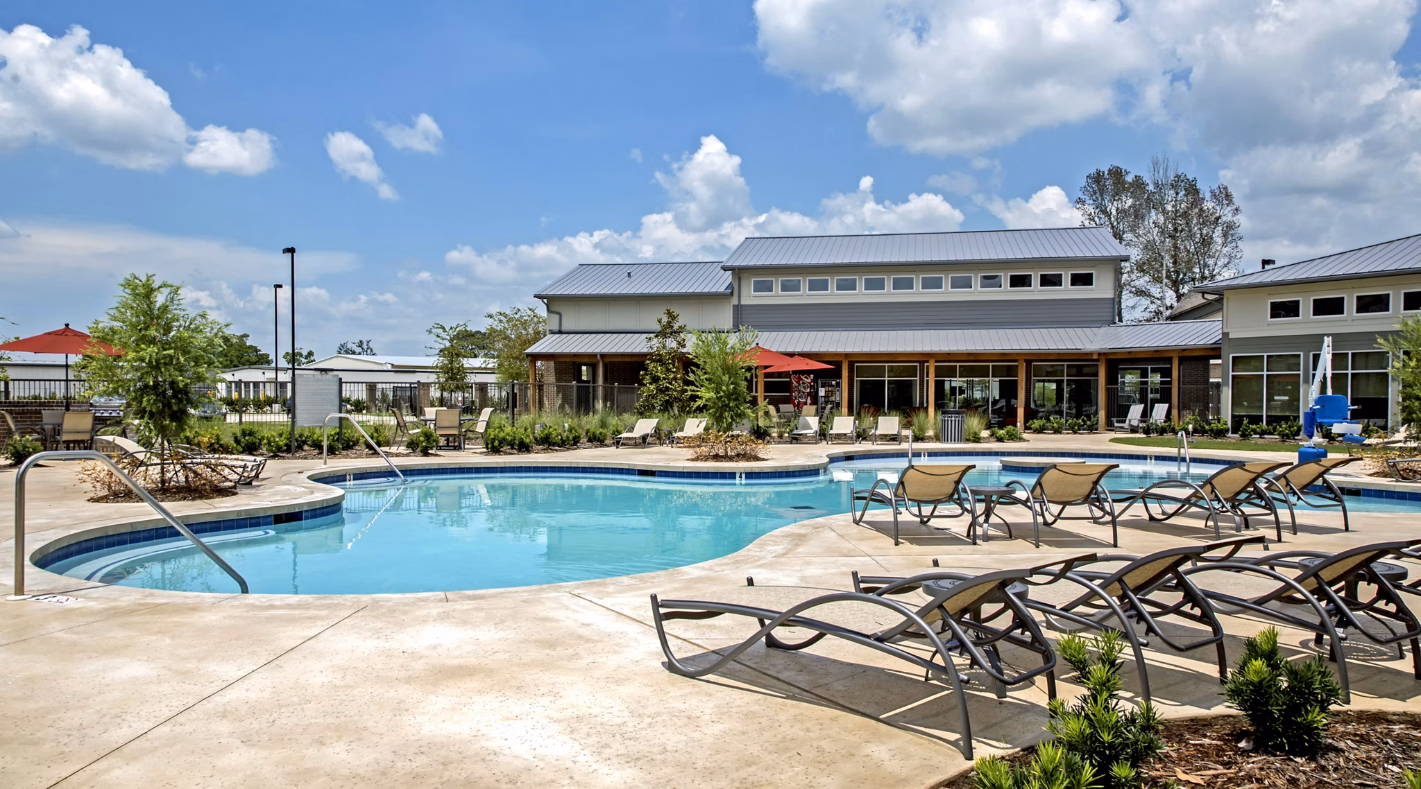 Resort-style pool at Watervue Apartments with lounge seating and landscaped surroundings