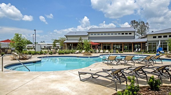 Resort-style pool at Watervue Apartments with lounge seating and landscaped surroundings