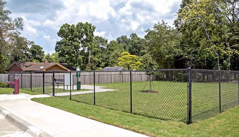 Dog-friendly park at Watervue Apartments with agility equipment and green space
