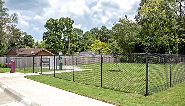 Dog-friendly park at Watervue Apartments with agility equipment and green space