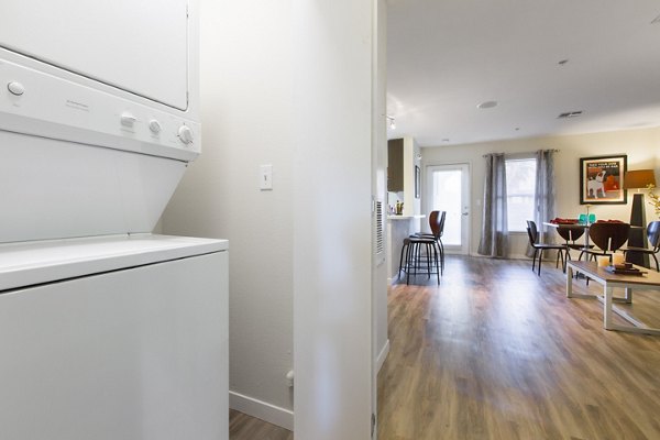 Energy-efficient washer and dryer set in laundry room at The U Apartments, offering convenient in-unit amenities for residents