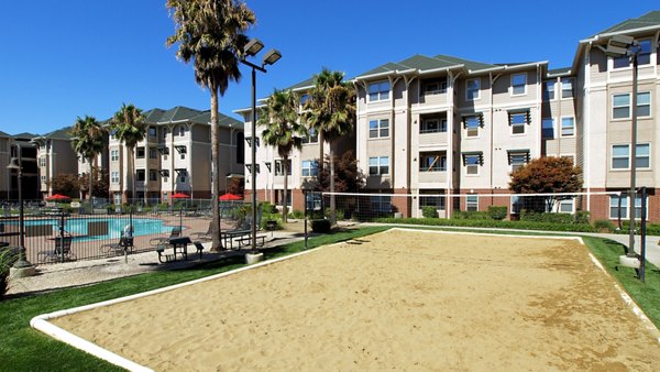 Beach volleyball court at The U Apartments offers recreational fun in a luxury Greystar community setting