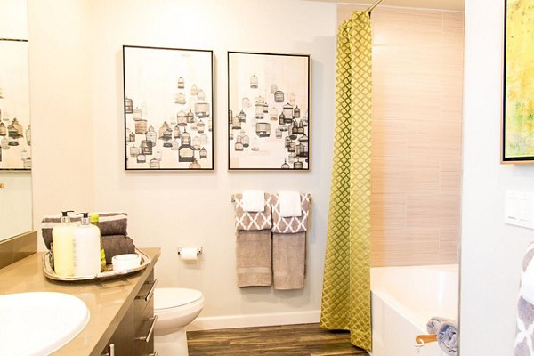 Modern bathroom featuring sleek fixtures and ample lighting in Dylan Point Loma Apartments