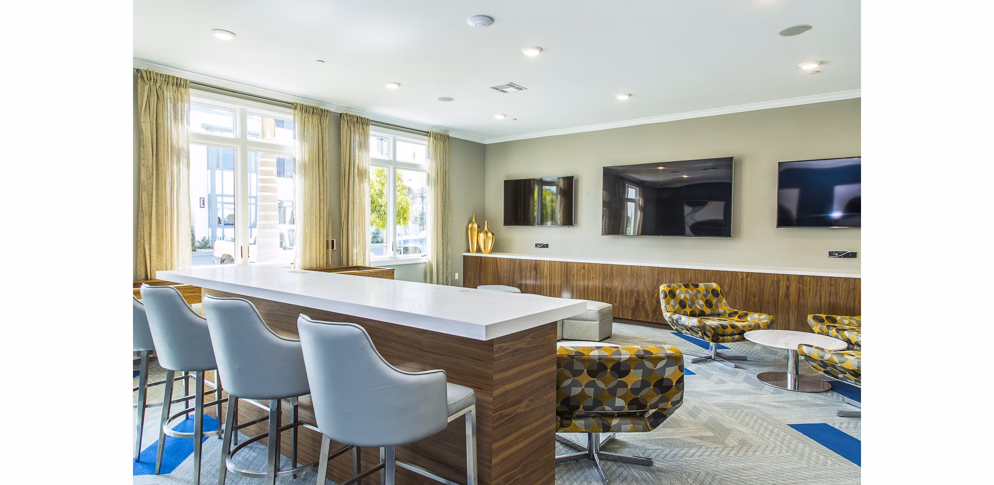 Modern game room featuring pool tables and arcade games at Dylan Point Loma Apartments