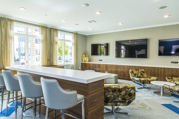 Modern game room featuring pool tables and arcade games at Dylan Point Loma Apartments
