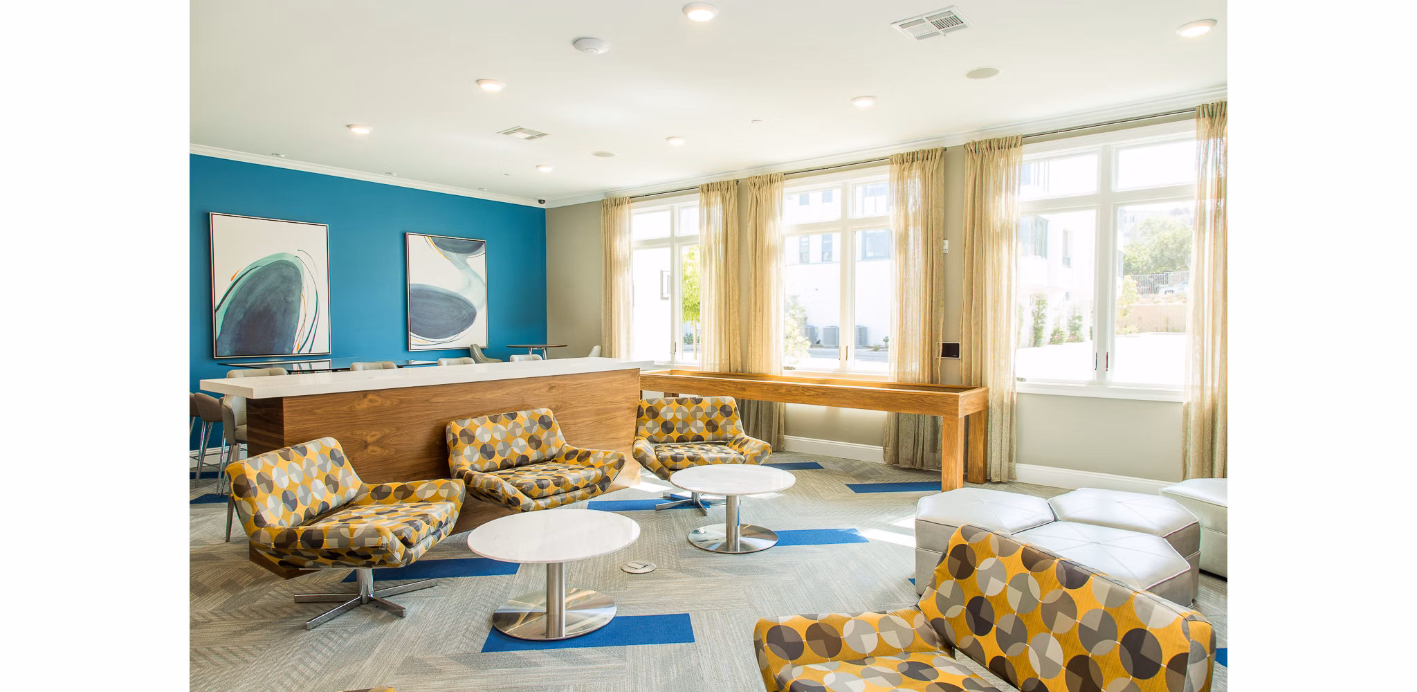 Modern game room with billiards tables and lounge seating at Dylan Point Loma Apartments