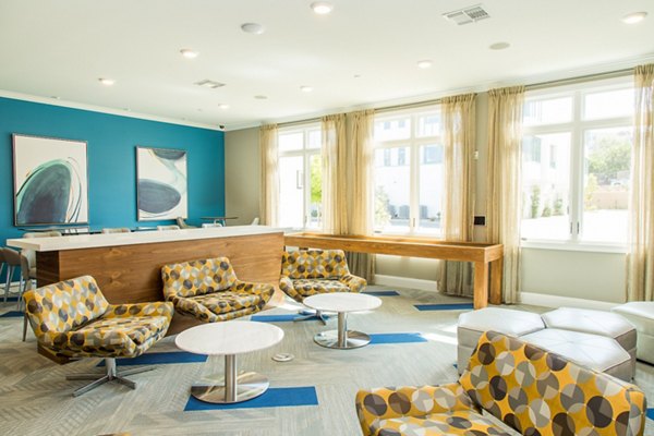 Modern game room with billiards tables and lounge seating at Dylan Point Loma Apartments