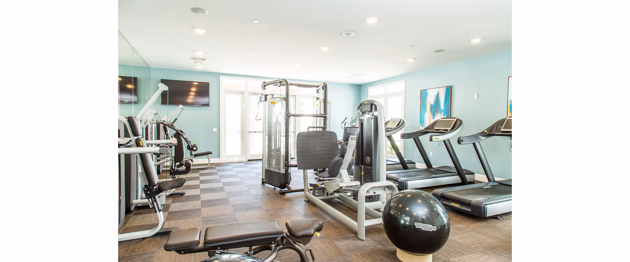 Fully-equipped fitness center with state-of-the-art machines at Dylan Point Loma Apartments