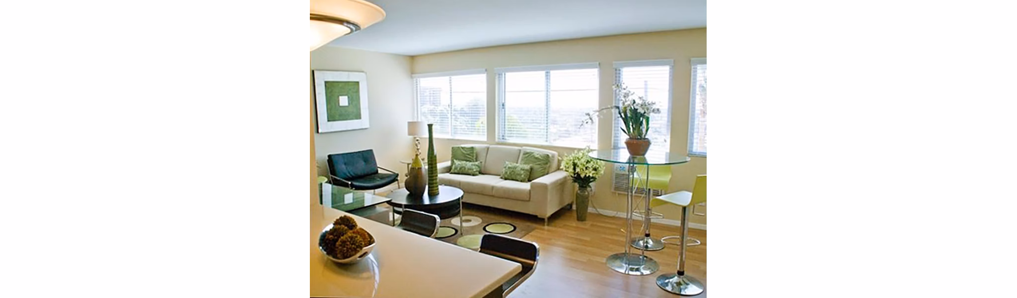 Living room with modern decor and large windows at Dylan Point Loma Apartments