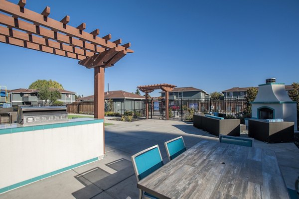 Grill area with outdoor seating at Woodside Park Apartments