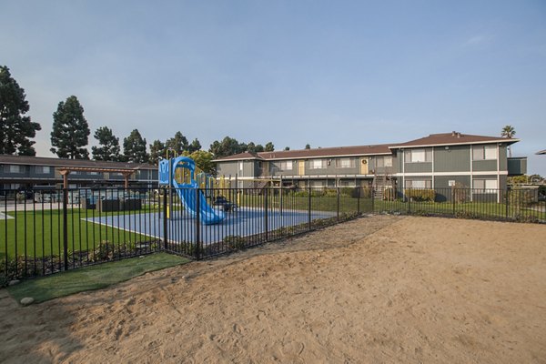 Colorful playground with slides and climbing structures at Woodside Park Apartments, ideal for families seeking luxury living