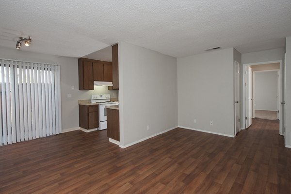 Living room with elegant decor and large windows at Sheridan Park Apartments