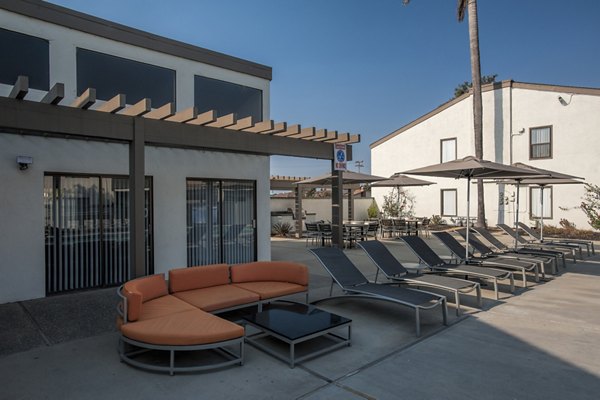 Poolside relaxation at Sheridan Park Apartments with luxurious seating and lush landscaping