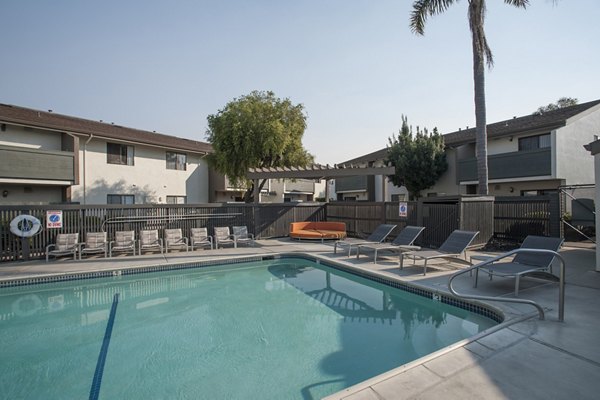 Resort-style pool with lounging areas at Sheridan Park Apartments
