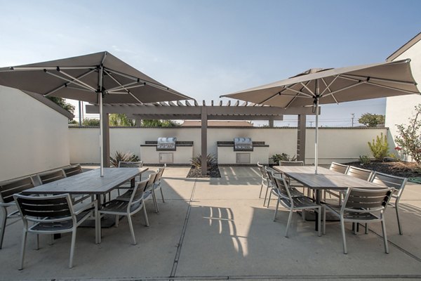 Grill area with modern outdoor seating at Sheridan Park Apartments