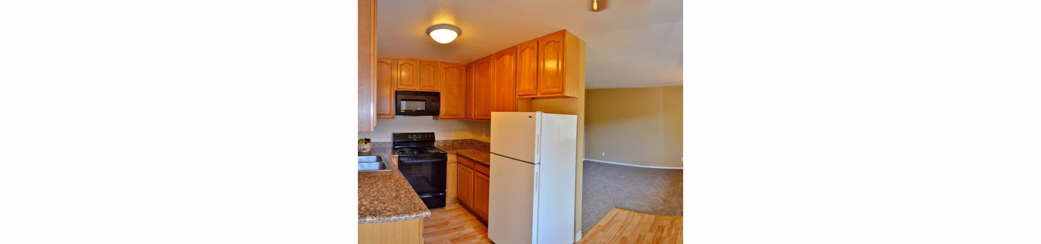 Modern kitchen with stainless steel appliances at Marina Crescent Apartments