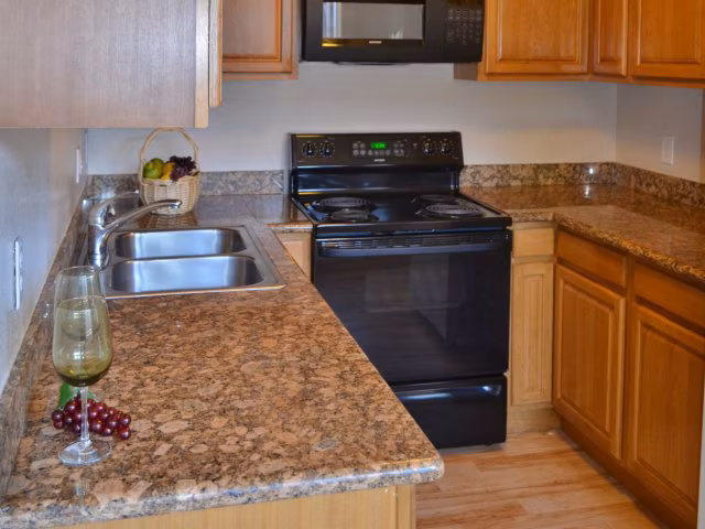 Kitchen showcasing modern appliances and quartz countertops at Marina Crescent luxury apartments