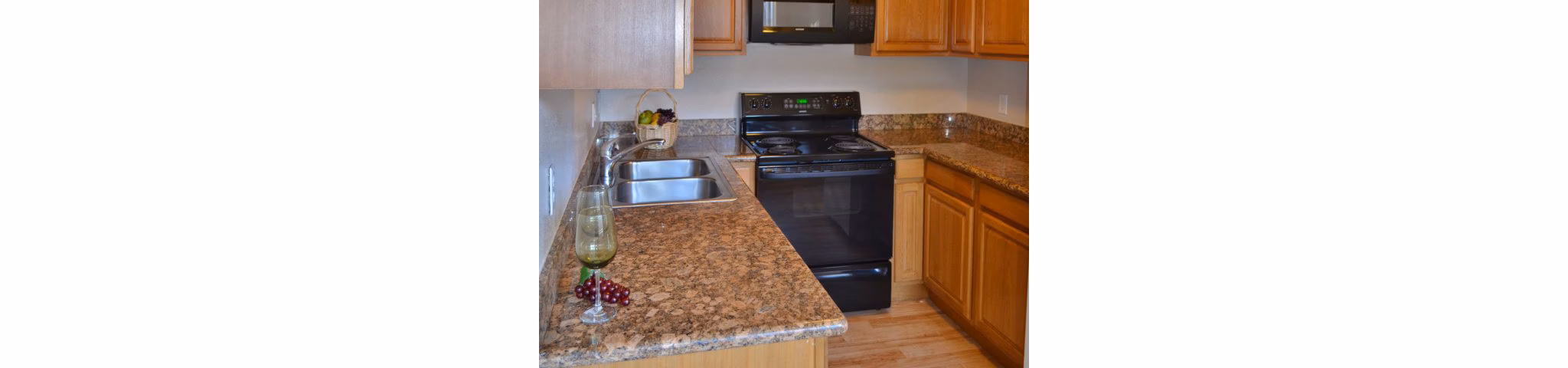 Kitchen showcasing modern appliances and quartz countertops at Marina Crescent luxury apartments