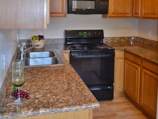 Kitchen showcasing modern appliances and quartz countertops at Marina Crescent luxury apartments