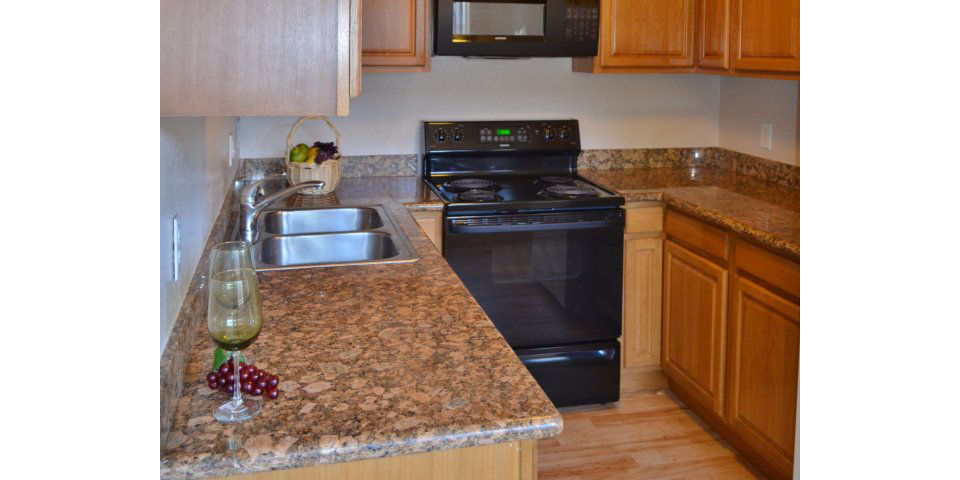 Kitchen showcasing modern appliances and quartz countertops at Marina Crescent luxury apartments