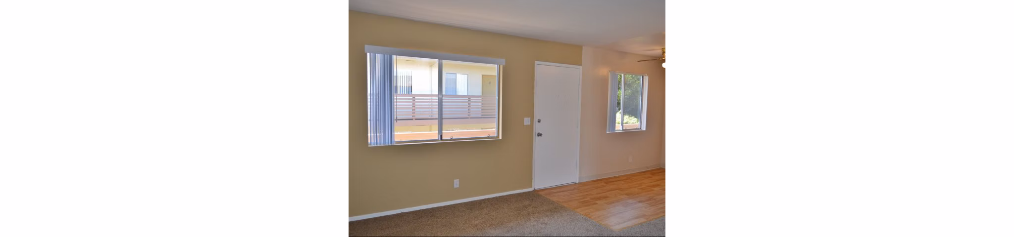 Elegant living room with modern decor and ample natural light at Marina Crescent Apartments