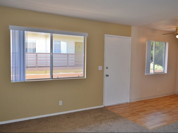 Elegant living room with modern decor and ample natural light at Marina Crescent Apartments