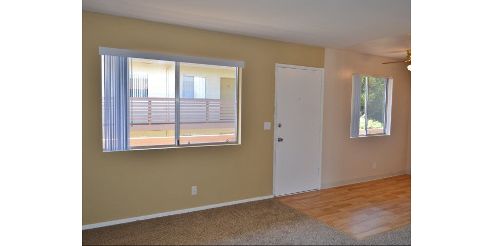 Elegant living room with modern decor and ample natural light at Marina Crescent Apartments