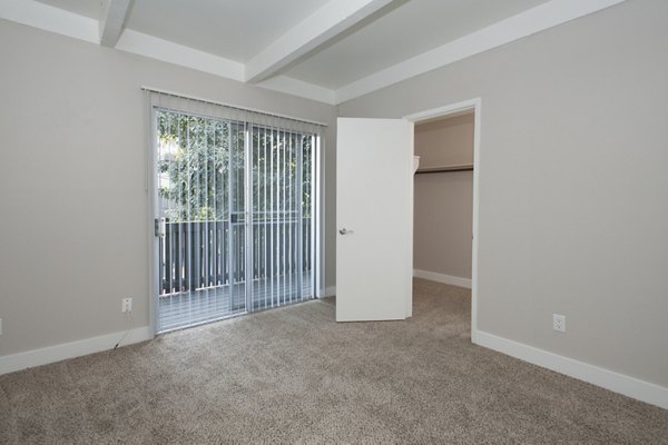 Cozy bedroom featuring modern design and natural light at Monterey Townhouse luxury apartments