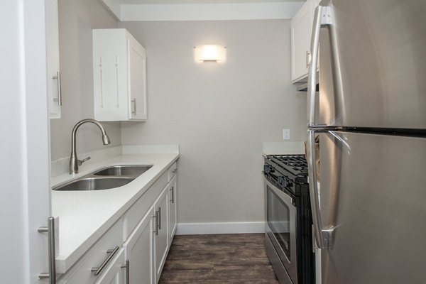 Modern kitchen with stainless steel appliances at Monterey Townhouse luxury apartments