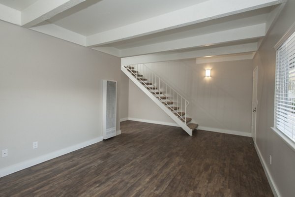 Living room with modern decor and large windows at Monterey Townhouse
