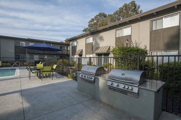 Grill area with modern outdoor seating at Monterey Townhouse luxury apartments