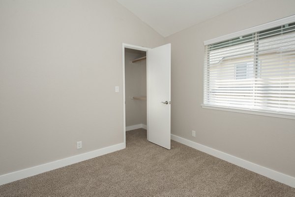 Luxurious bedroom with modern decor and ample natural light in Pacific Vista Apartments