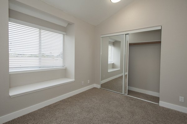 Cozy bedroom with modern furnishings at Pacific Vista Apartments, offering luxury living in a picturesque setting