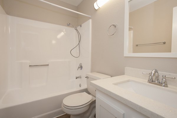 Modern bathroom with granite countertops and sleek fixtures at Pacific Vista Apartments, offering luxury living in a prime location