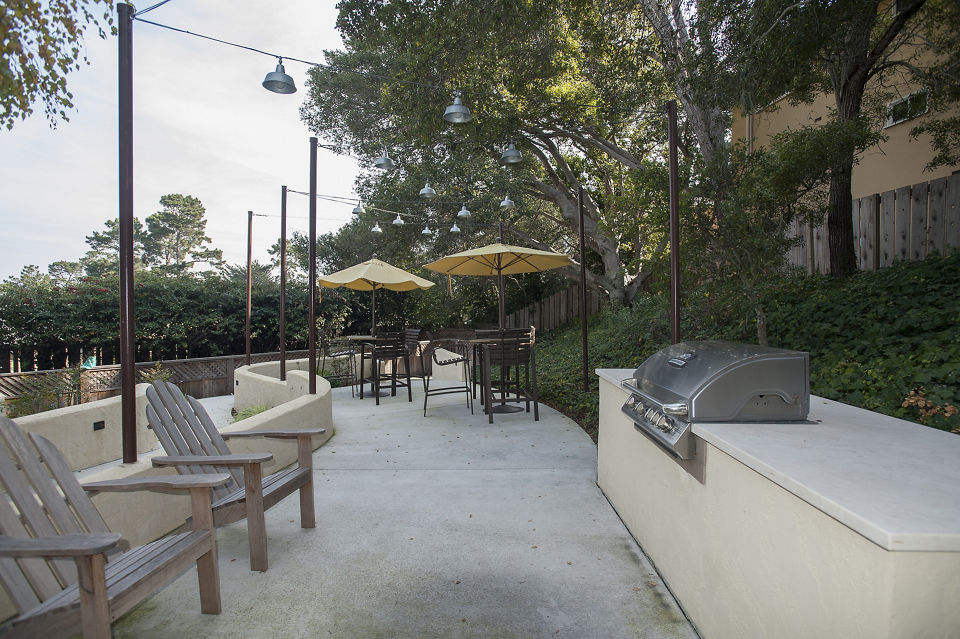 Outdoor grilling area with modern BBQ setups at Pacific Vista Apartments, perfect for social gatherings and relaxation